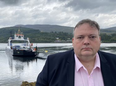 Jamie standing in front of the Mail of Glencoul ferry